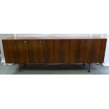 A Danish rosewood rectangular sideboard with four cupboards mounted on four chrome supports,