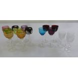 A quantity of eight coloured cut glass liqueur glasses and seven other small glasses