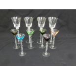 Six coloured liqueur glasses and four claret glasses with barley twist stems