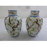 A pair of Victorian milk glass vases decorated with flowers and leaves, A/F