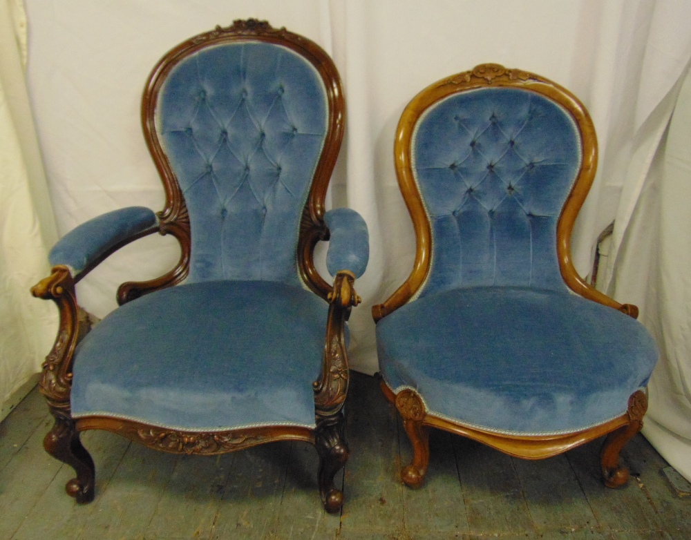 A Victorian upholstered mahogany armchair and a matching ladies chair