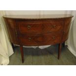 A mahogany Regency style D shaped sideboard with two drawers and two cupboards on tapering