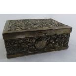 A white metal rectangular cigarette box profusely chased with flowers and leaves, stamped 925