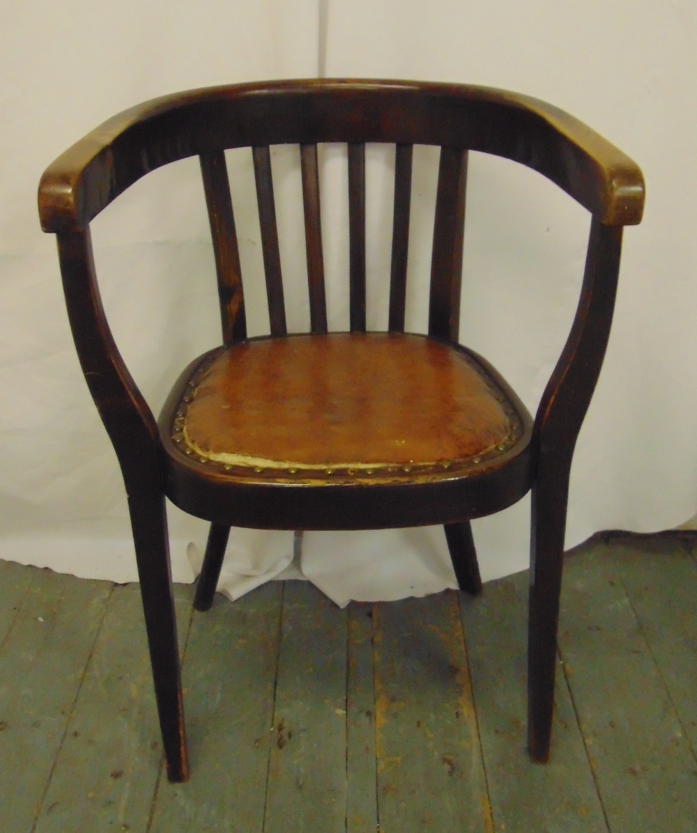 An Arts and Crafts mahogany armchair with leather seat on tapering rectangular legs