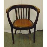 An Arts and Crafts mahogany armchair with leather seat on tapering rectangular legs