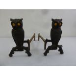A pair of fire irons in the form of owls with glass eyes