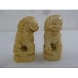 A pair of late 19th century Oriental ivory dogs of foe