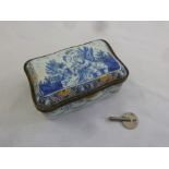 A 19th century shaped rectangular porcelain and brass musical box, the cover with an image of a