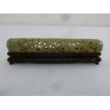 A Chinese cylindrical jade scroll holder carved and pierced with prunus blossom and leaves with