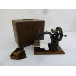 An antique Wilcox and Gibbs sewing machine in fitted case