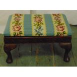 A Victorian rectangular upholstered stool on four scroll legs