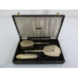 A cased four piece engine turned silver dressing table set comprising mirror, comb and hair brush