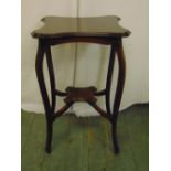 An Edwardian mahogany occasional table of shaped rectangular form on four cabriole legs