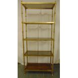 A gilded metal five tier rectangular display stand with glass and wooden shelves