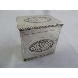 A silver rectangular tea caddy the sides and hinged cover with stylised conch shells and rope