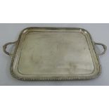 A Mappin and Webb hallmarked silver two handled rounded rectangular tray with shell chased scroll