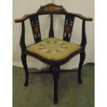 An Edwardian corner chair with pierced slat backs upholstered seat on four scroll legs