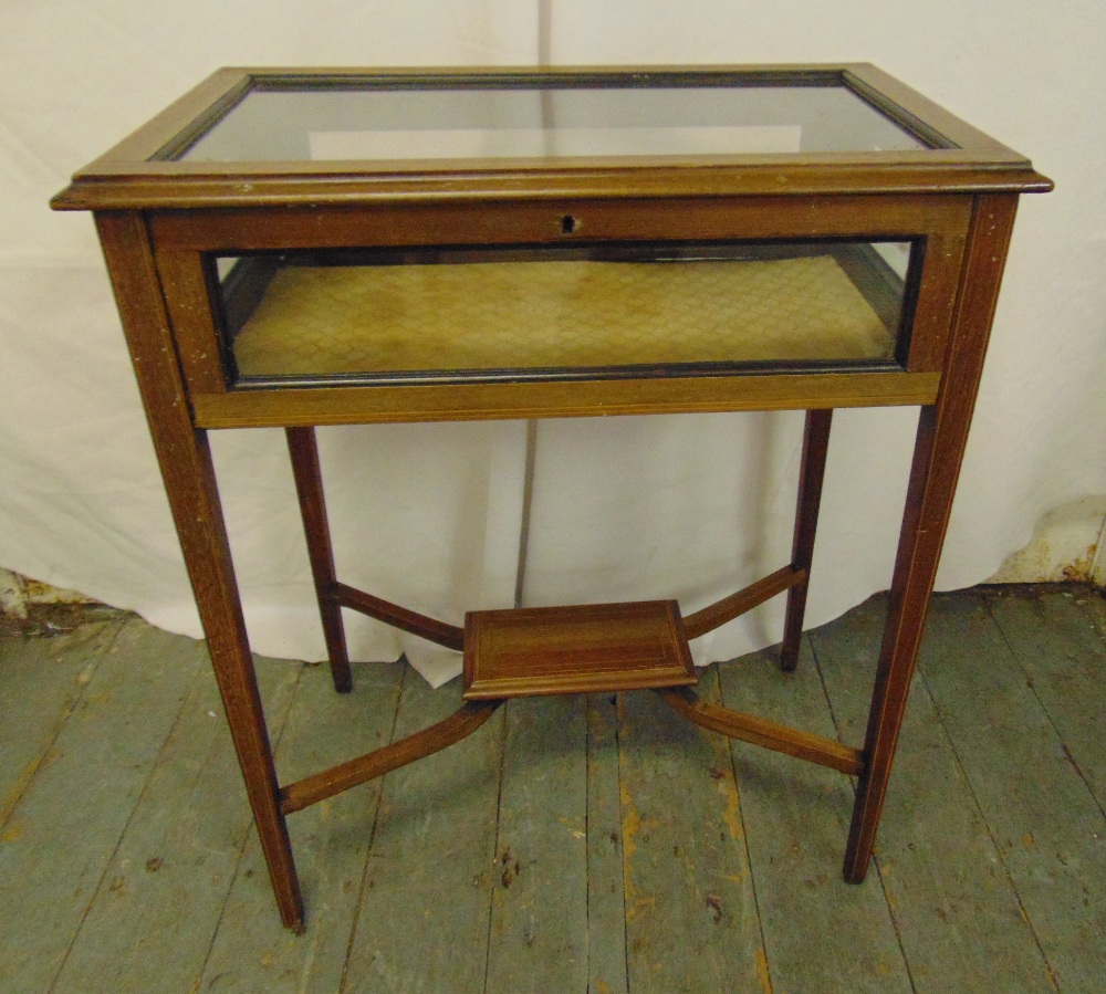 An Edwardian rectangular mahogany and glass display table on four tapering legs