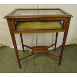 An Edwardian rectangular mahogany and glass display table on four tapering legs