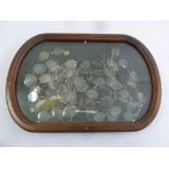 A quantity of vintage and antique spectacles of various forms in oval glazed wooden display case