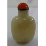 A Chinese jade snuff bottle of rounded rectangular form with domed pull off cover