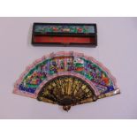 A Chinese 19th century hand painted lacquered and silk fan, sixteen section, in original