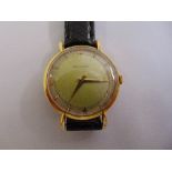 A vintage Jaeger LeCoultre gentlemans wristwatch on black leather strap, tested 18ct gold