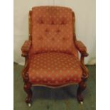 Victorian mahogany upholstered armchair on four scroll legs and castors