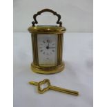 Matthew Norman miniature brass oval carriage clock, to include key