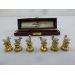 Garrard and Company a cased set of menu holders in the form of cast silver ducks on turned silver