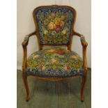 An occasional armchair with fluted scrolling arms and legs and tapestry upholstery