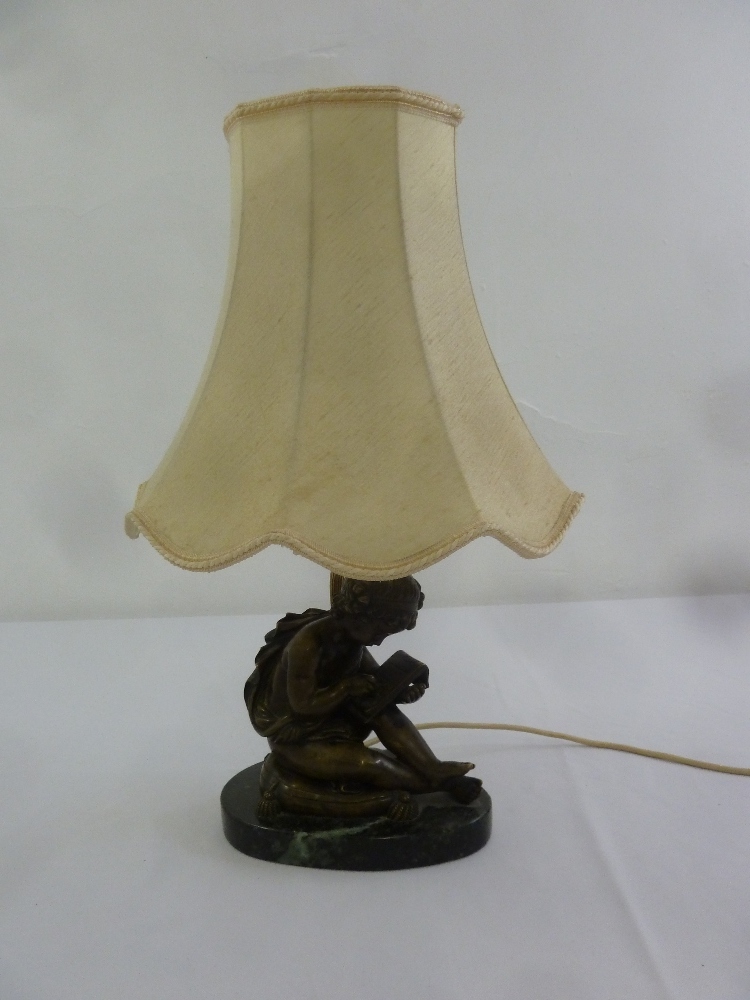 A bronze figural table lamp with silk shade