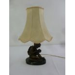 A bronze figural table lamp with silk shade