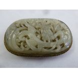 A Chinese mutton fat jade and gilt metal belt buckle, carved and pierced with leaves and flowers