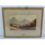 A framed and glazed watercolour of a country landscape with hills in the background and figures in