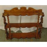 A mahogany three tier wall shelf with barley twist supports