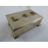 A silver engine turned rectangular cigarette box on four bracket feet the hinged cover with