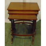 A mahogany nest of three rectangular tables