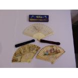 Two 19th century French hand painted fans and an Oriental ivory and silk embroidered fan, all in