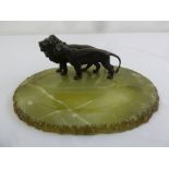 An onyx shaped oval desk stand with an applied bronze figurine of a lion and lioness