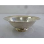 A Georg Jensen sterling silver circular hand hammered bowl on flared circular foot