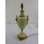 An onyx and gilt metal table lamp of ovoid form on raised circular base