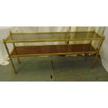 A rectangular gilded metal two tier hall table with glass and wooden shelves