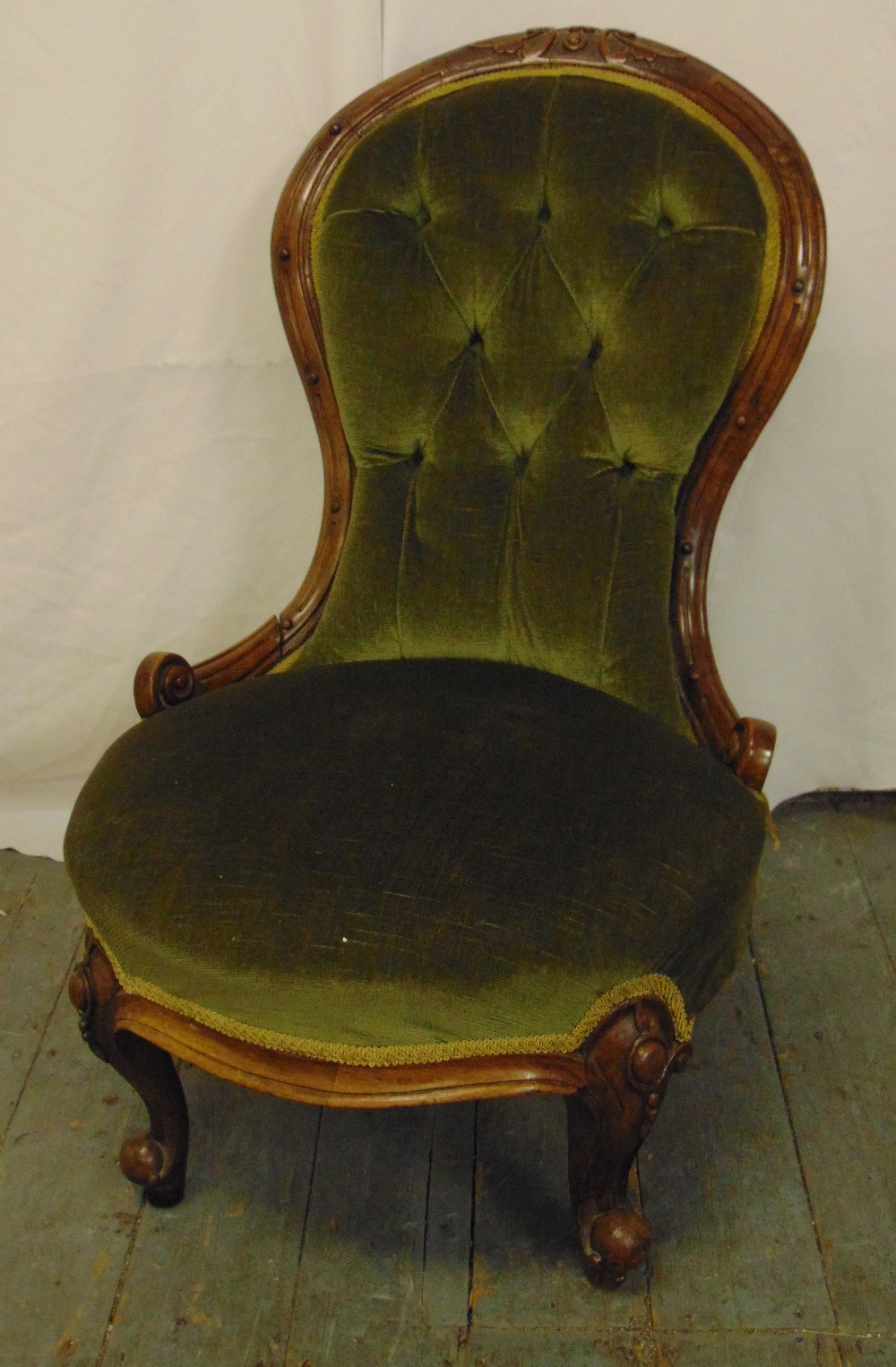 A Victorian button back ladies chair on scroll legs