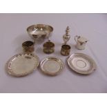 A quantity of silver and white metal to include napkin rings, coasters, condiments and a bonbon