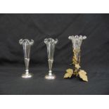 A pair of silver mounted Edwardian bud vases and a glass vase with gilt metal mounts (3)