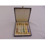 A cased set of Danish yellow metal and enamel pastry forks