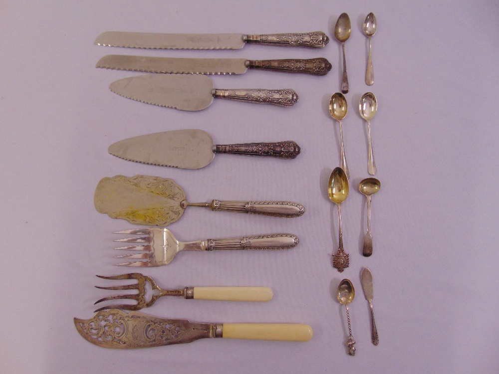 A quantity of silver and white metal spoons and servers