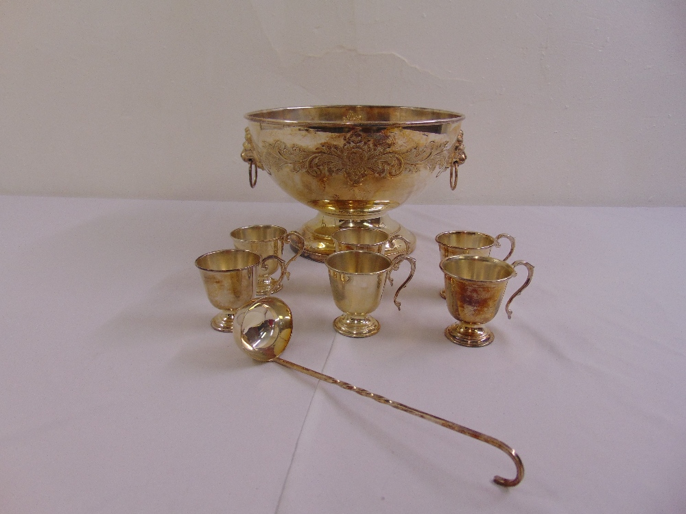 A silver plated punch bowl, six silver plated cups and a silver plated ladle