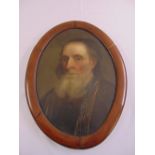 A framed oval oil on canvas portrait of a scholar, 44 x 33cm